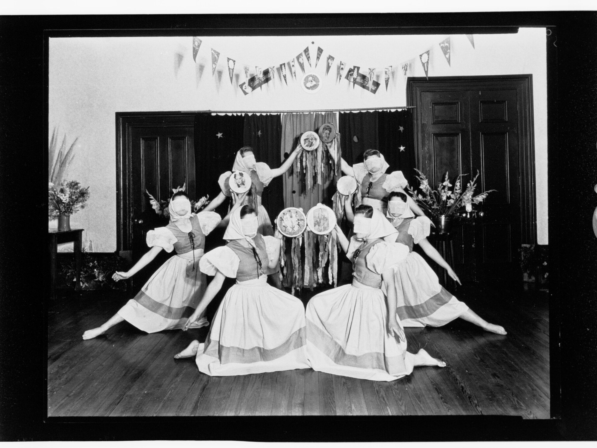Children's Welfare Department - young women dancing in costume with masks