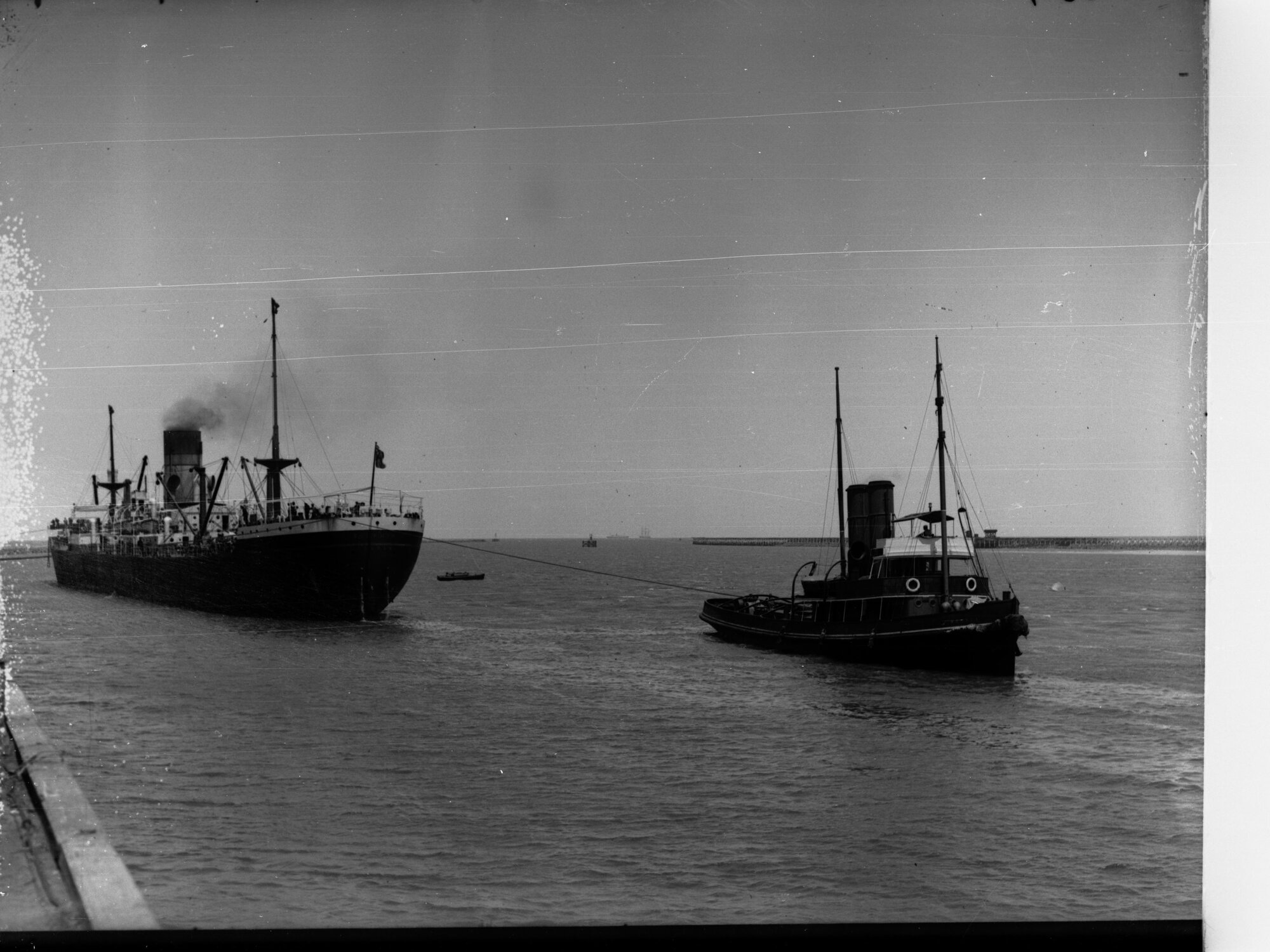 Steamship Delphic of London Being Pulled by Tugboat Woonda
