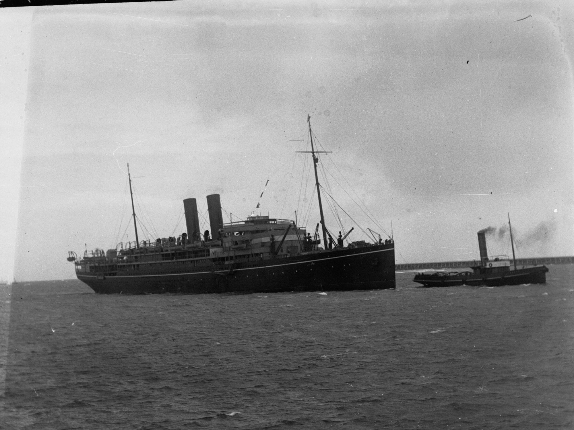 Steamship "RMS Maloja" being tugged by tug boat - Outer Harbour