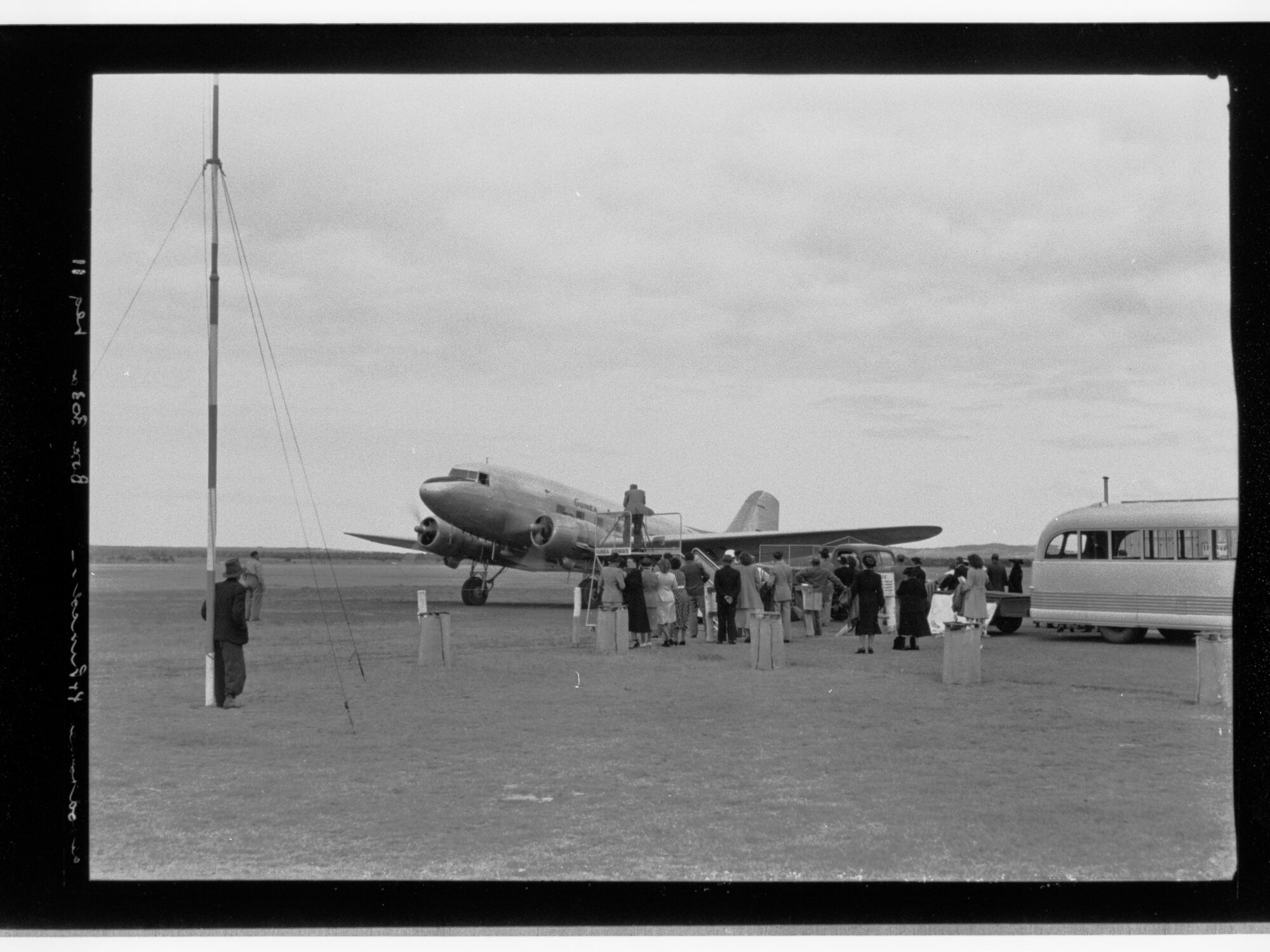 People standing around Guinea Airways Ltd plane