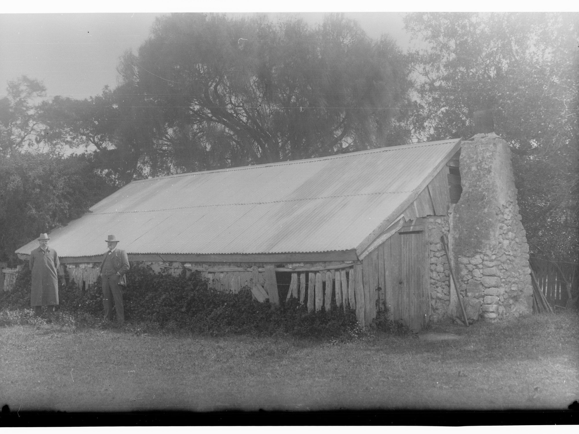 Hut with two men standing in front