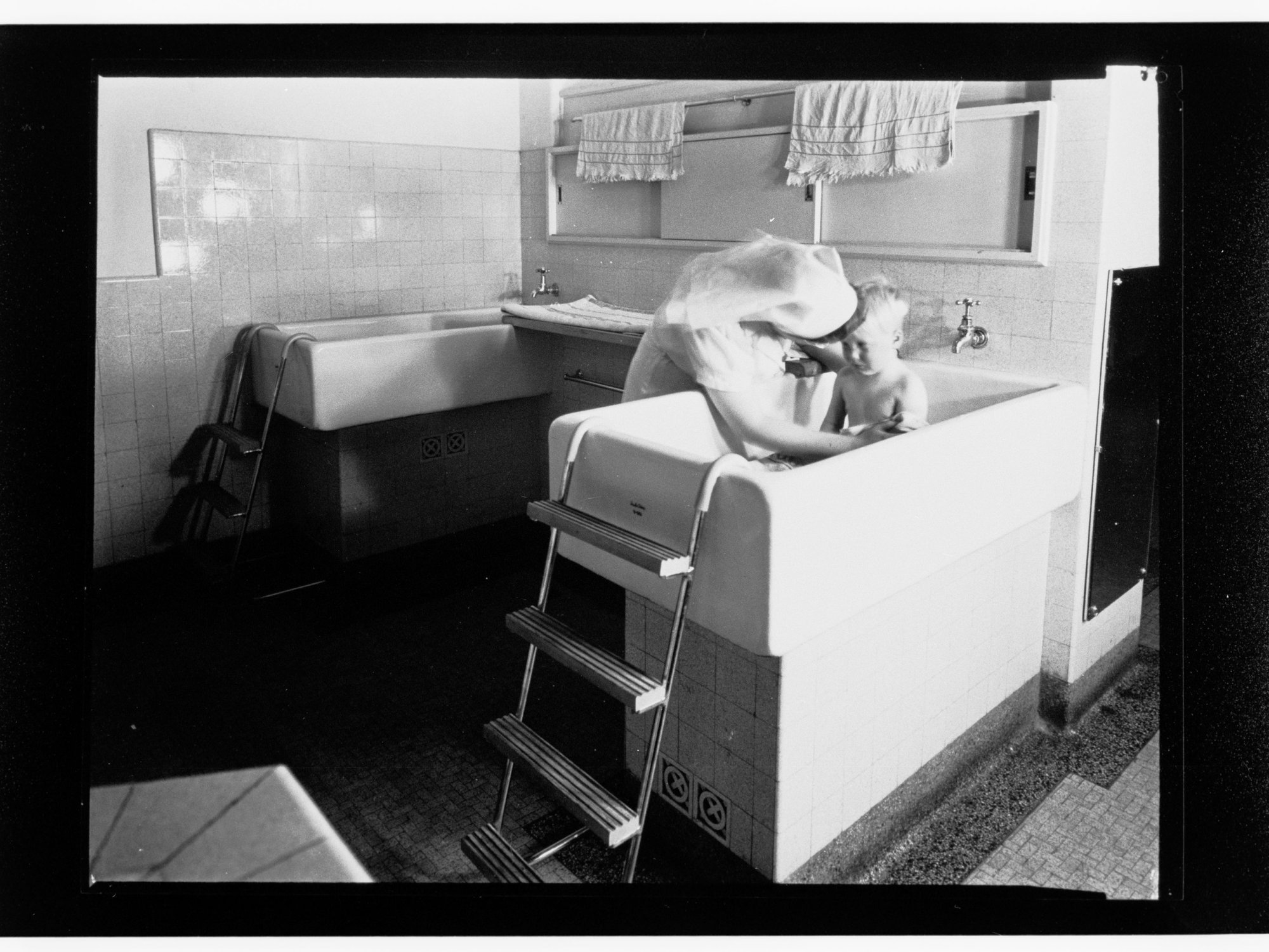 Children's Welfare Department - nurse bathing child