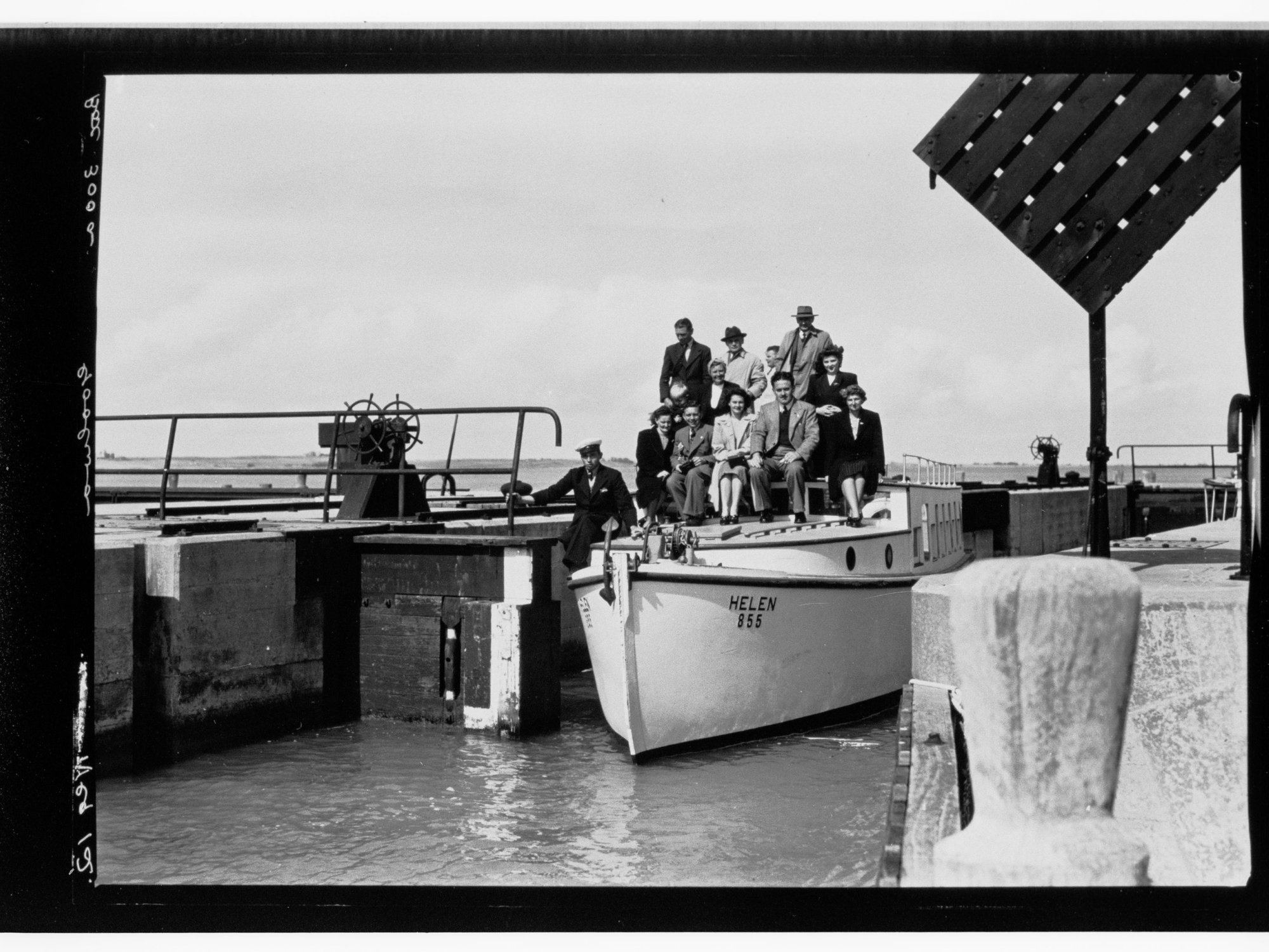 Goolwa - people sitting on top of small boat next to pier