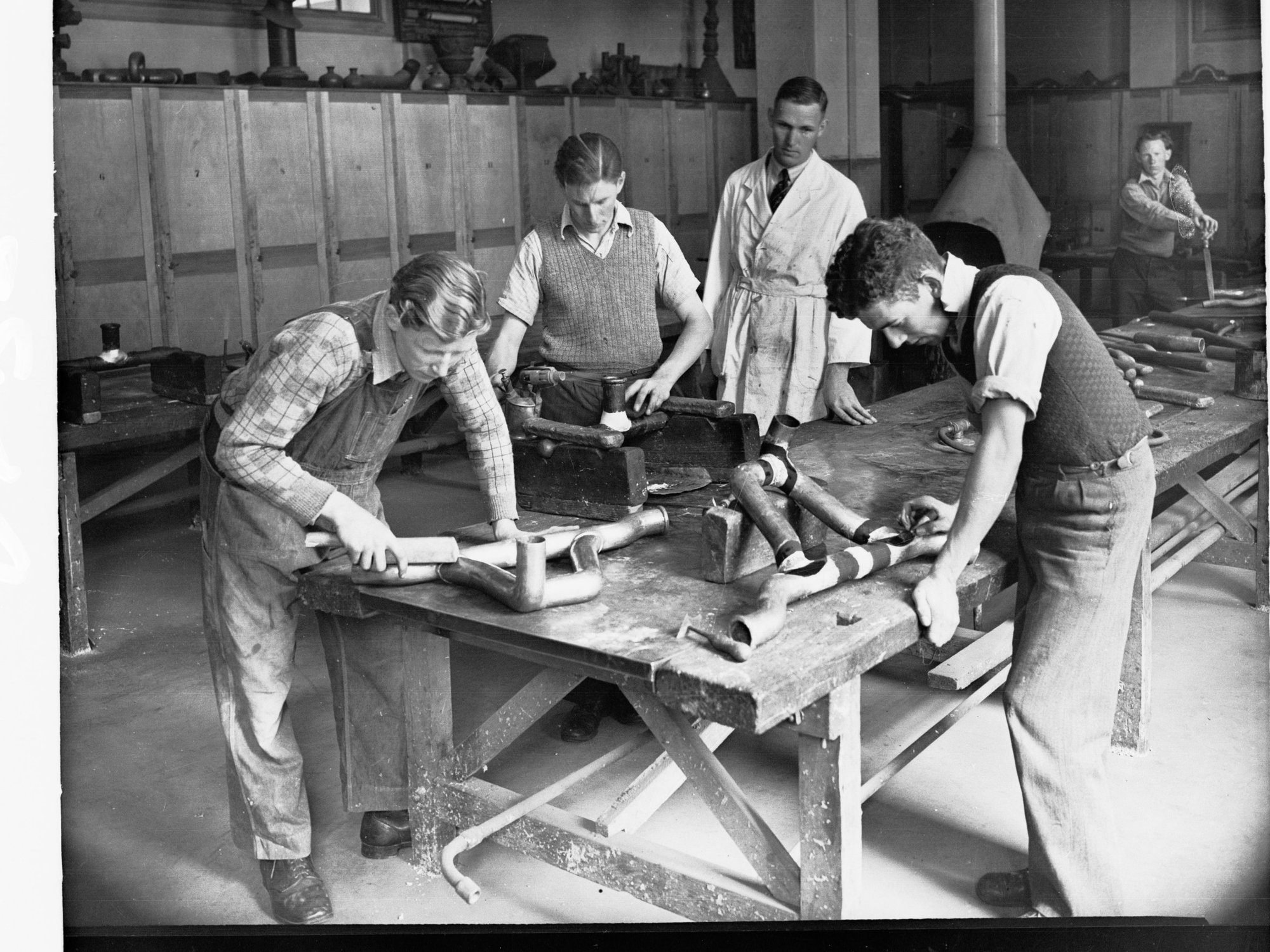 Students Working in Sheet Metalwork Room With Copper Piping