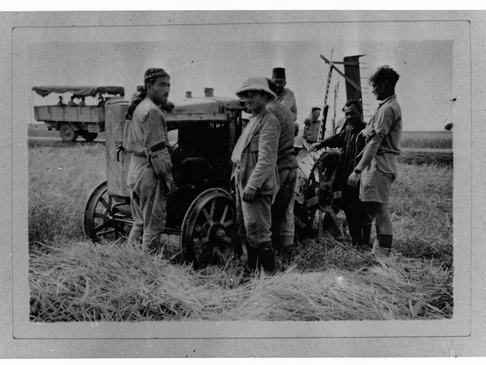 Men around harvester