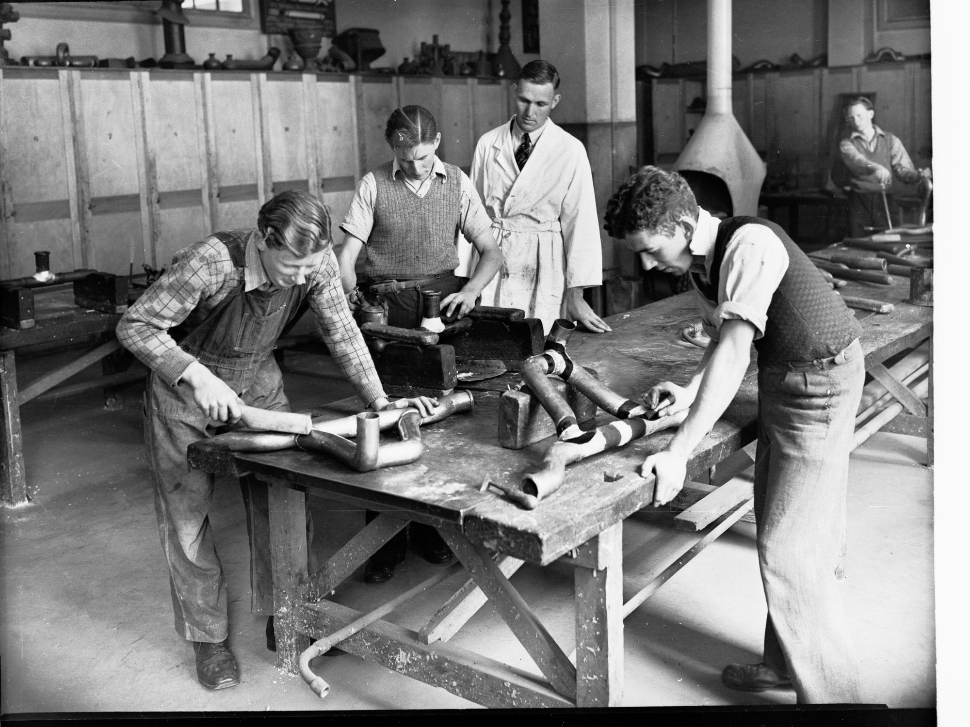 Plumbers Trade School Students Working on Pipes