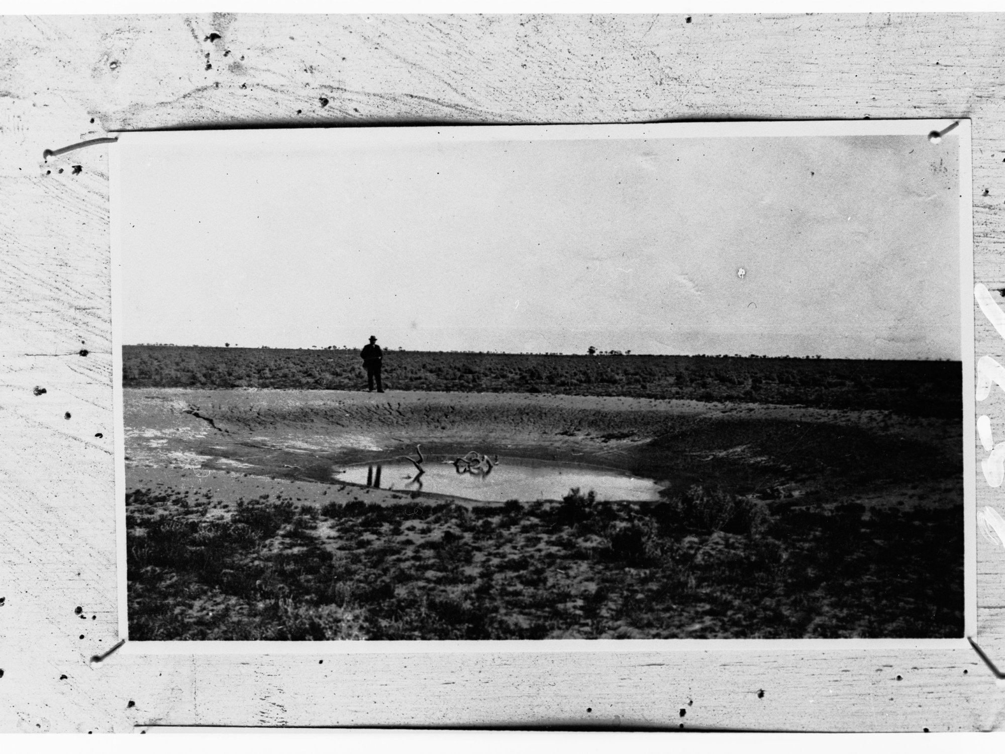 Man by a waterhole - location unknown