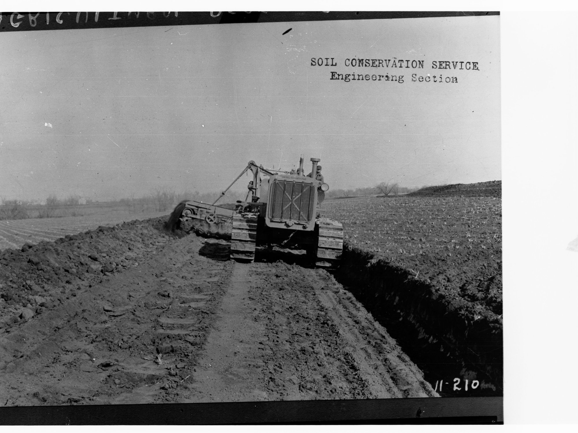 Agricultural Department, men checking wheat, showing tractor