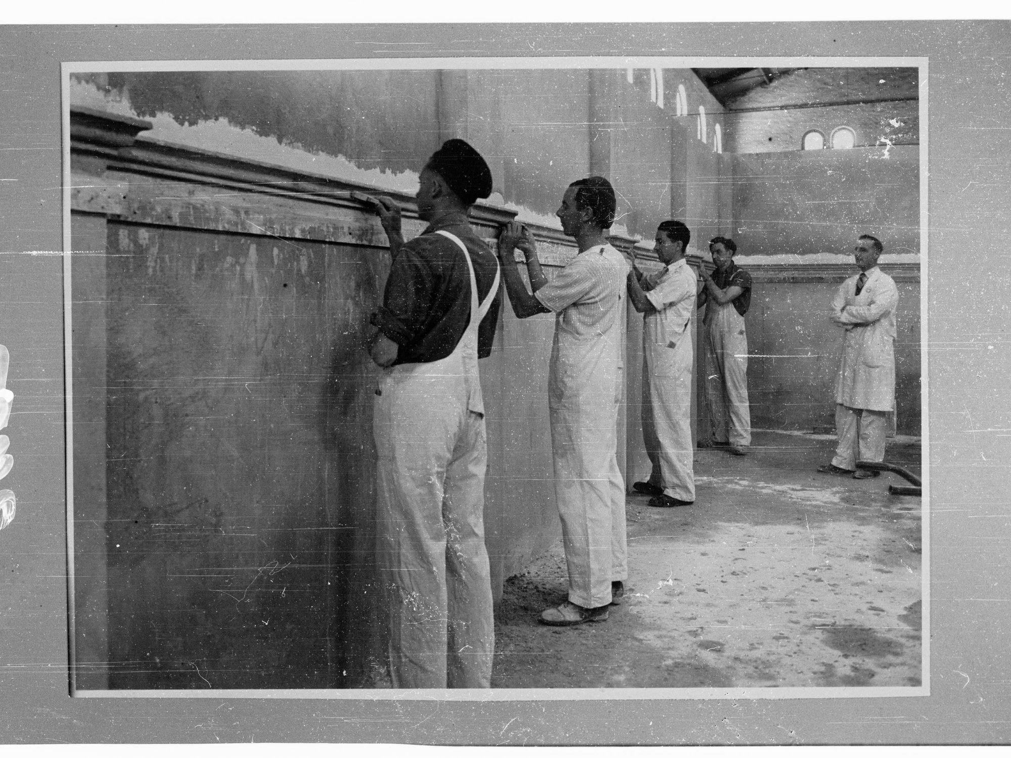 Reconstruction training school - Education Dept. - men plastering walls