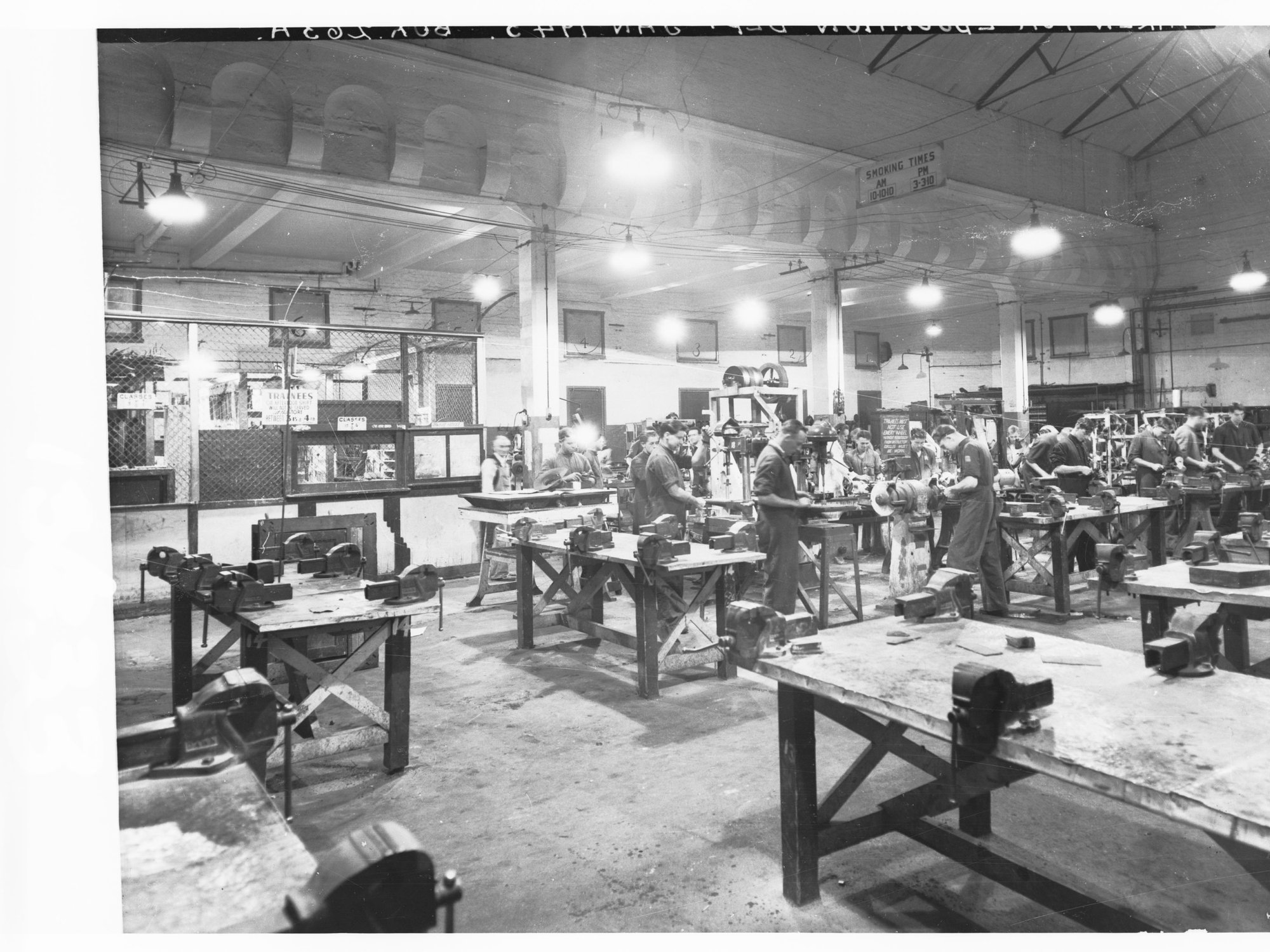 Grenfell Street Trades School Showing old lighting system in woodwork room, students at work