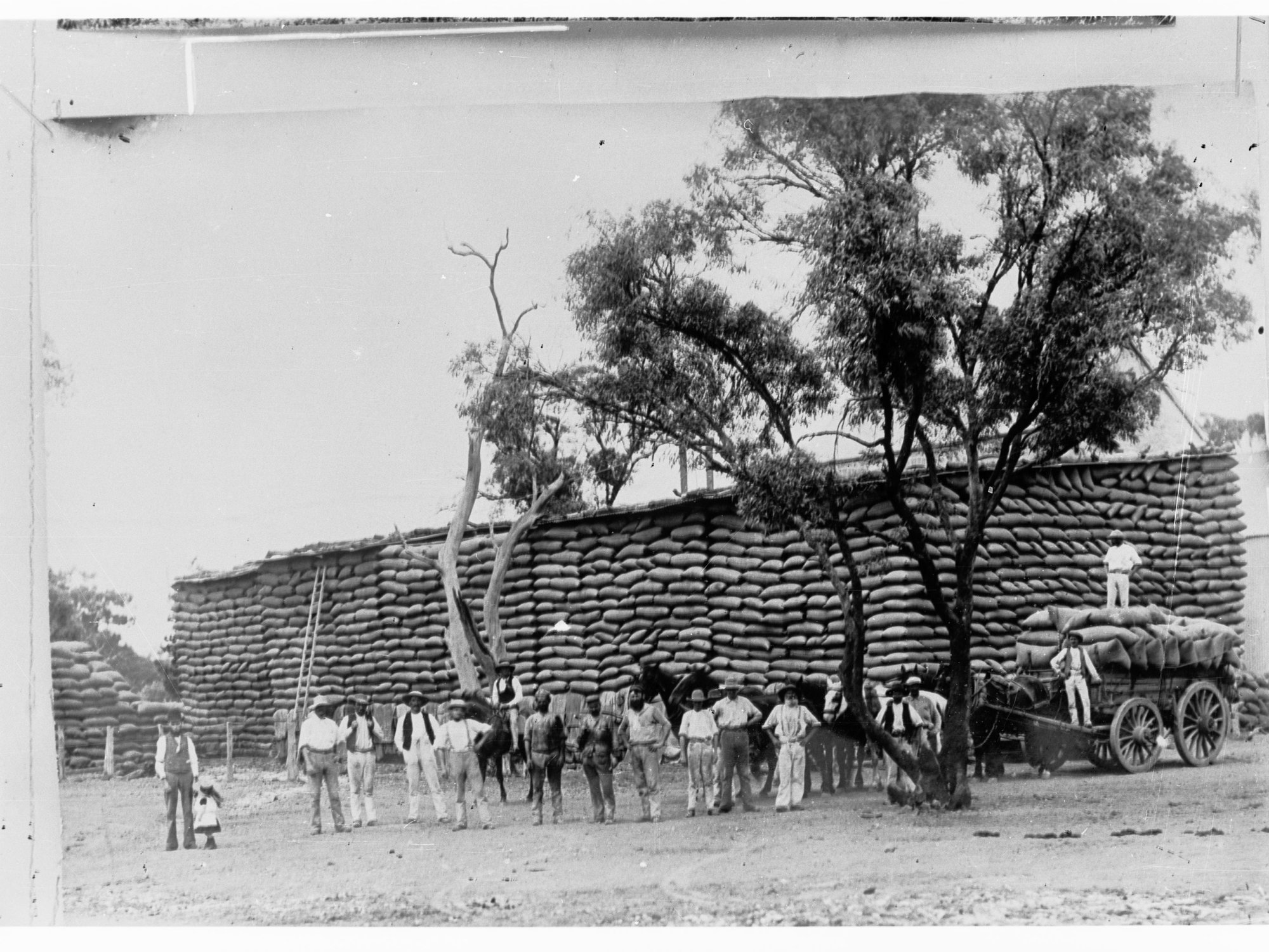 Northern Territory - wheat stacks and a carload of wheat waiting to be unloaded