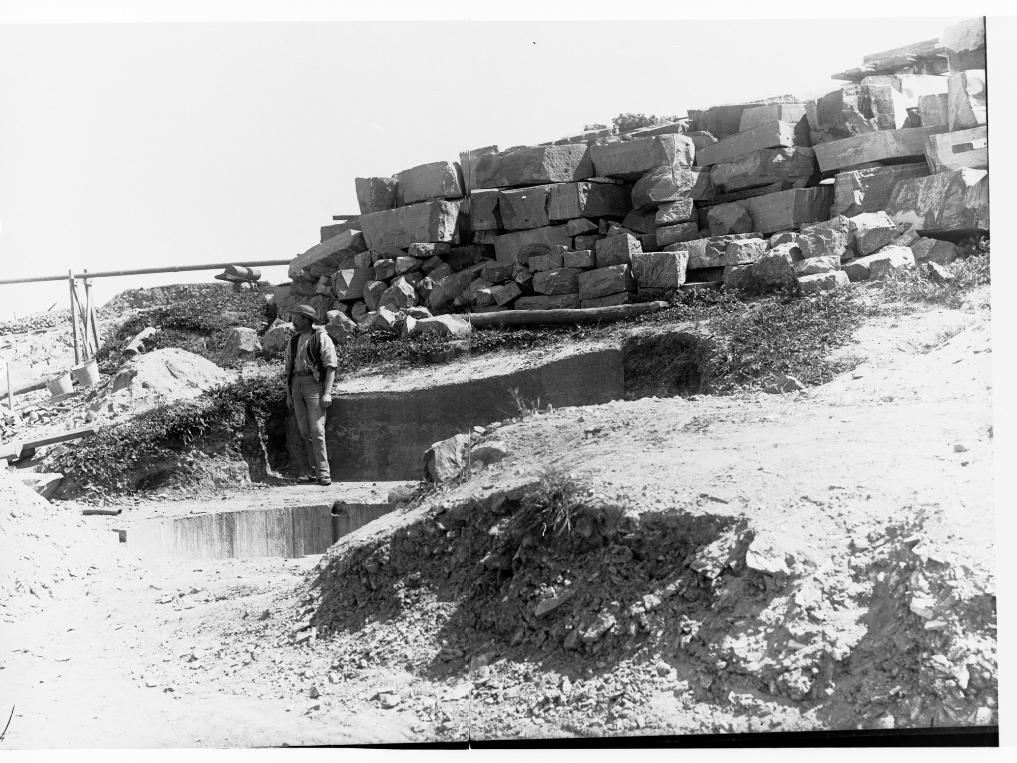 A construction worker stands  beside the Happy Valley Waterworks