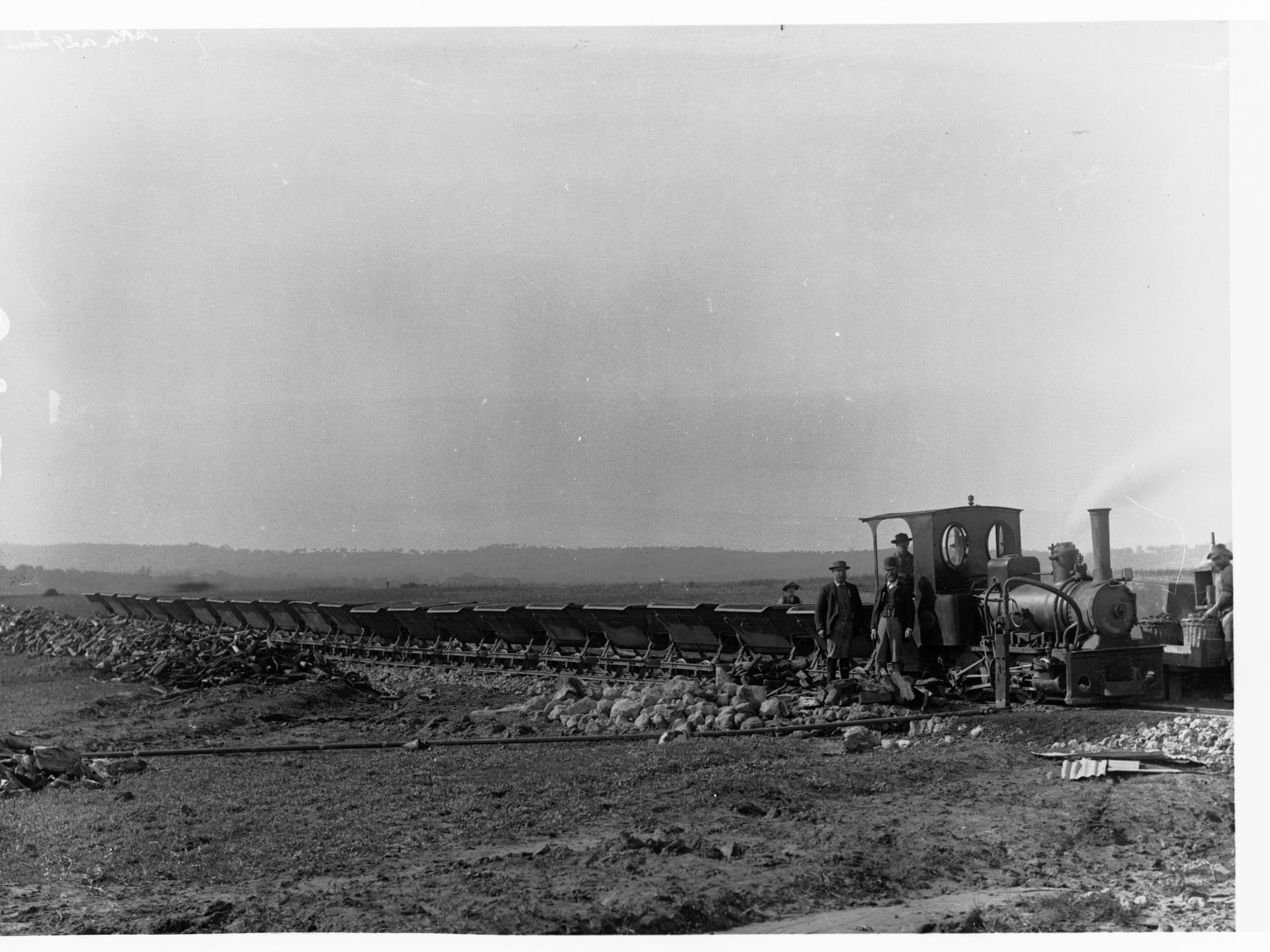 Construction of Happy Valley Reservoir dam wall  - showing small steam train