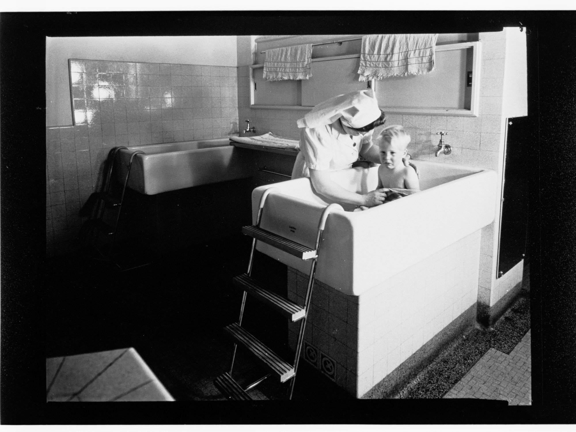 Children's Welfare Department - nurse bathing child
