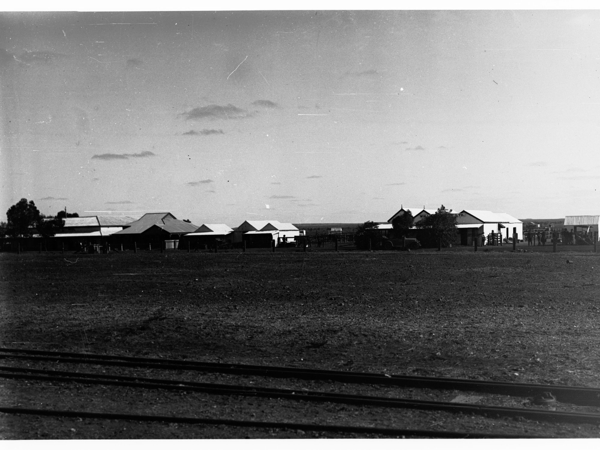 Parliamentary party on tour of Far North in Austin cars (government cars) - shows Oodnadatta railway line and houses