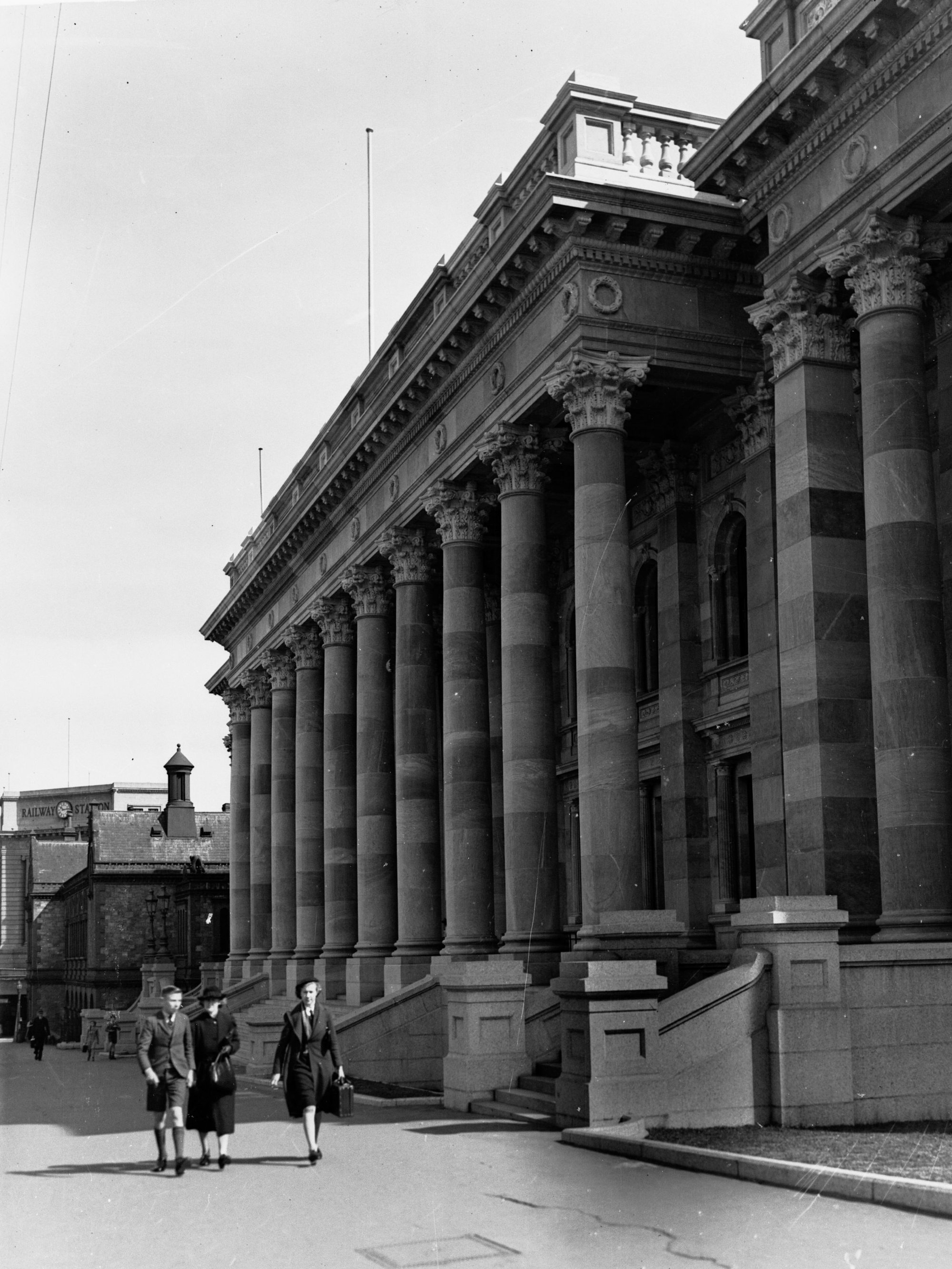 Front of Parliament House looking towards railway station, people walking on the pavement also showing