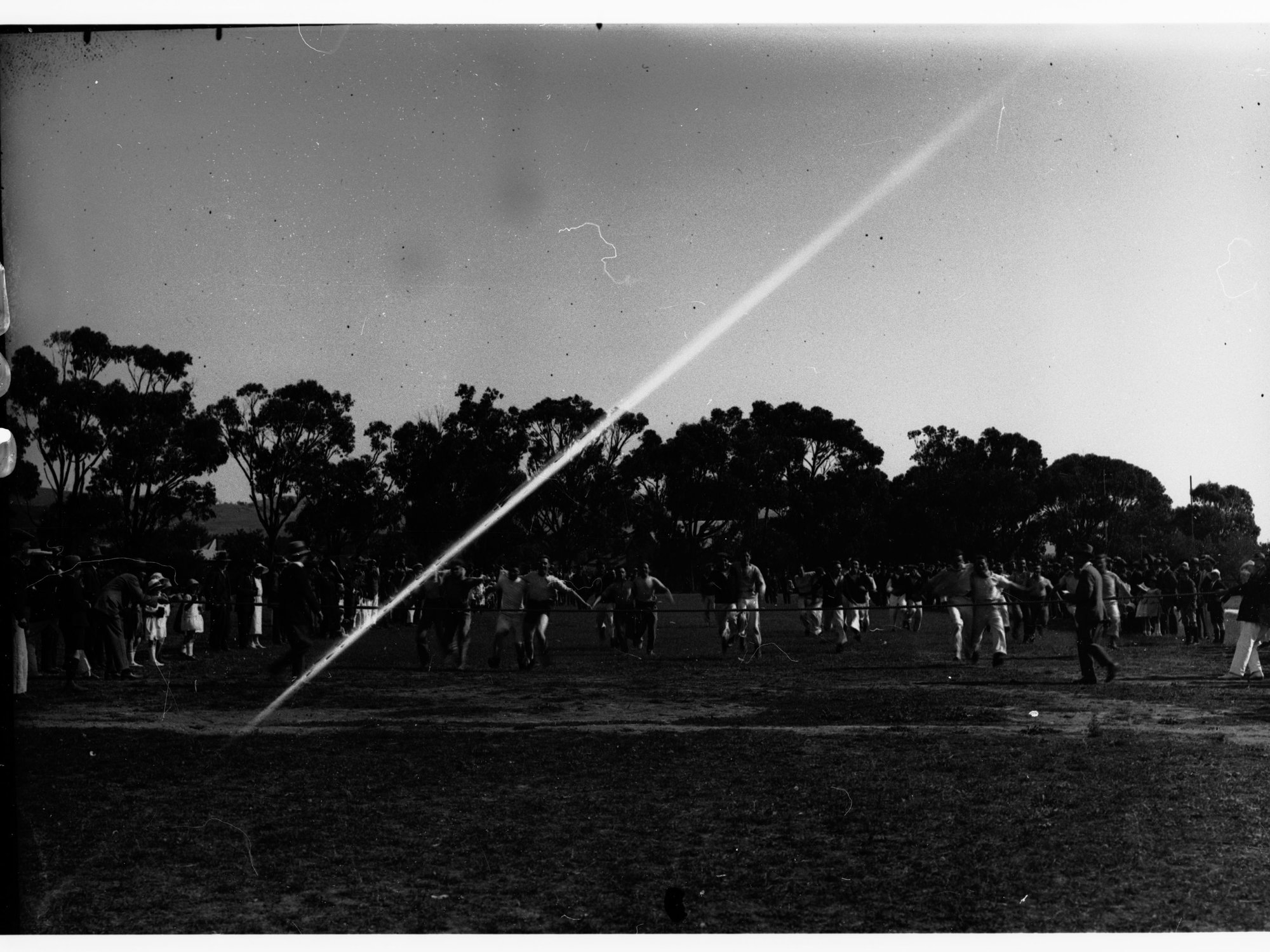 Sailors from HMS Hood running in a three-legged race at Willunga