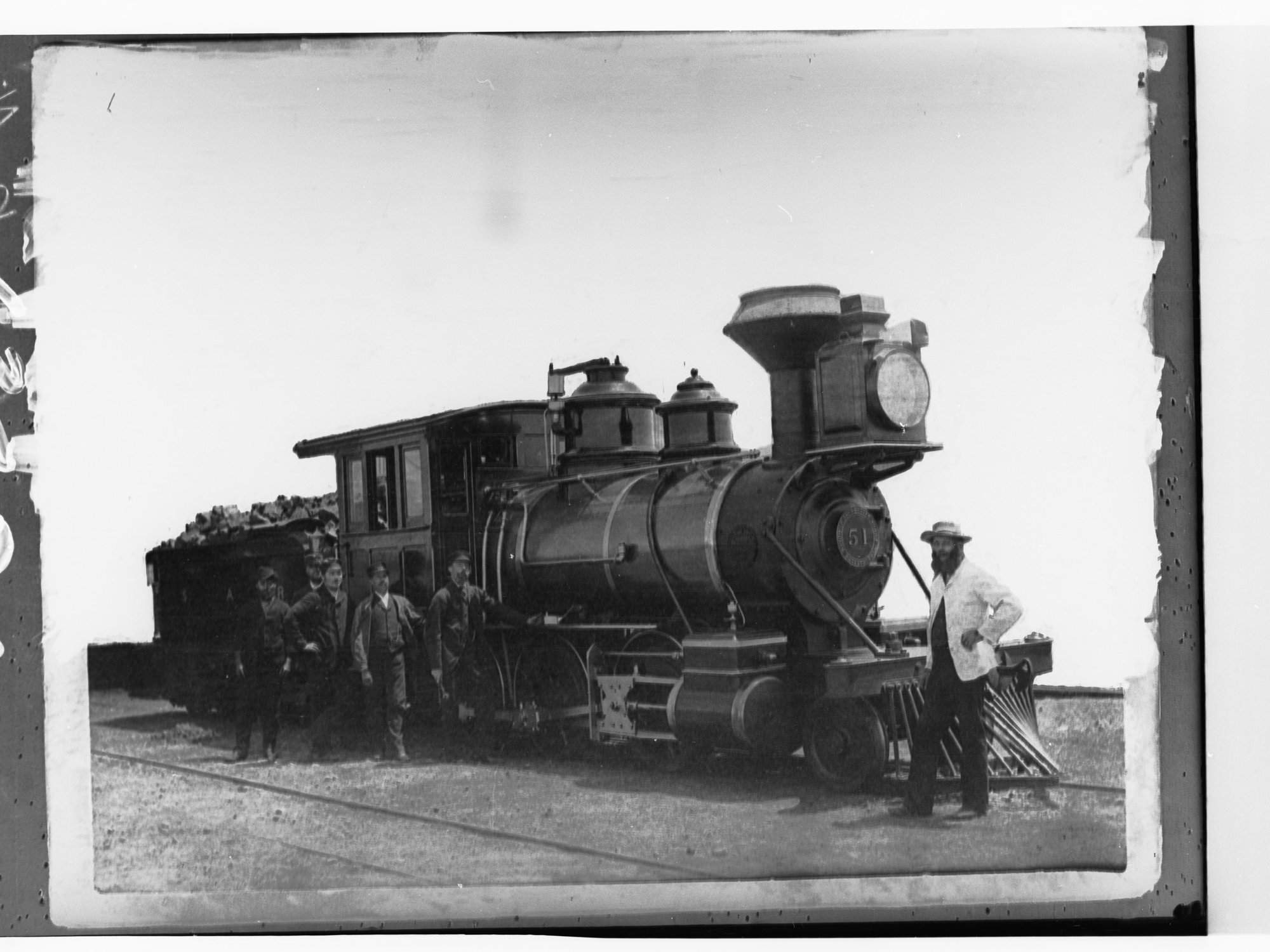 Steam locomotive showing railway employees