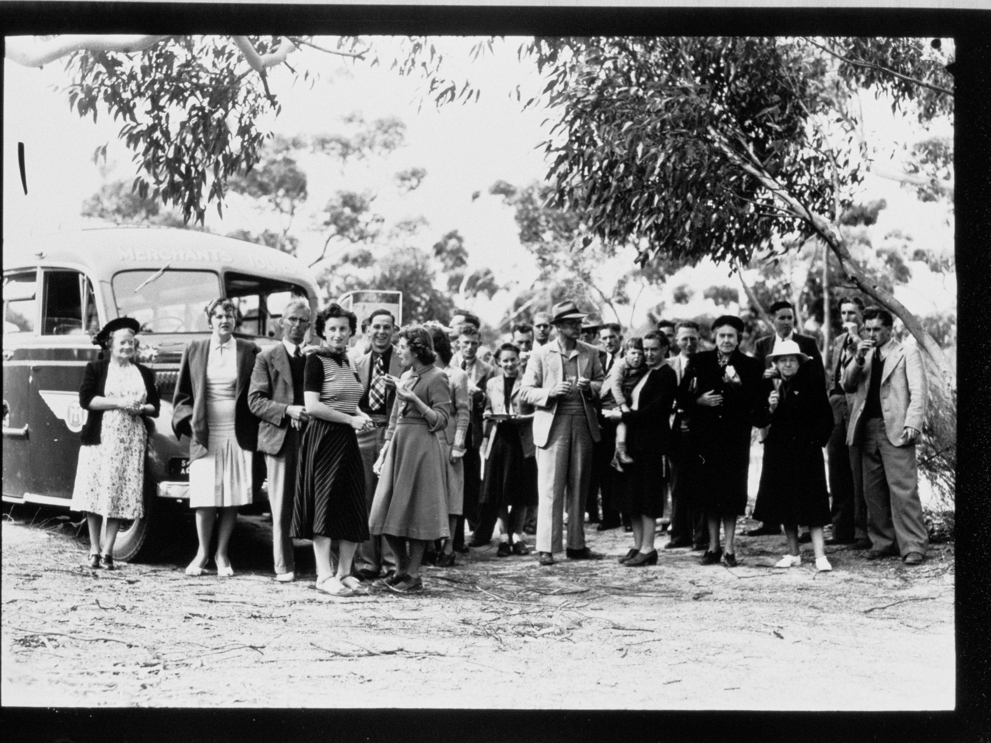 People standing in front of Merchant Tours bus - Coffin Bay