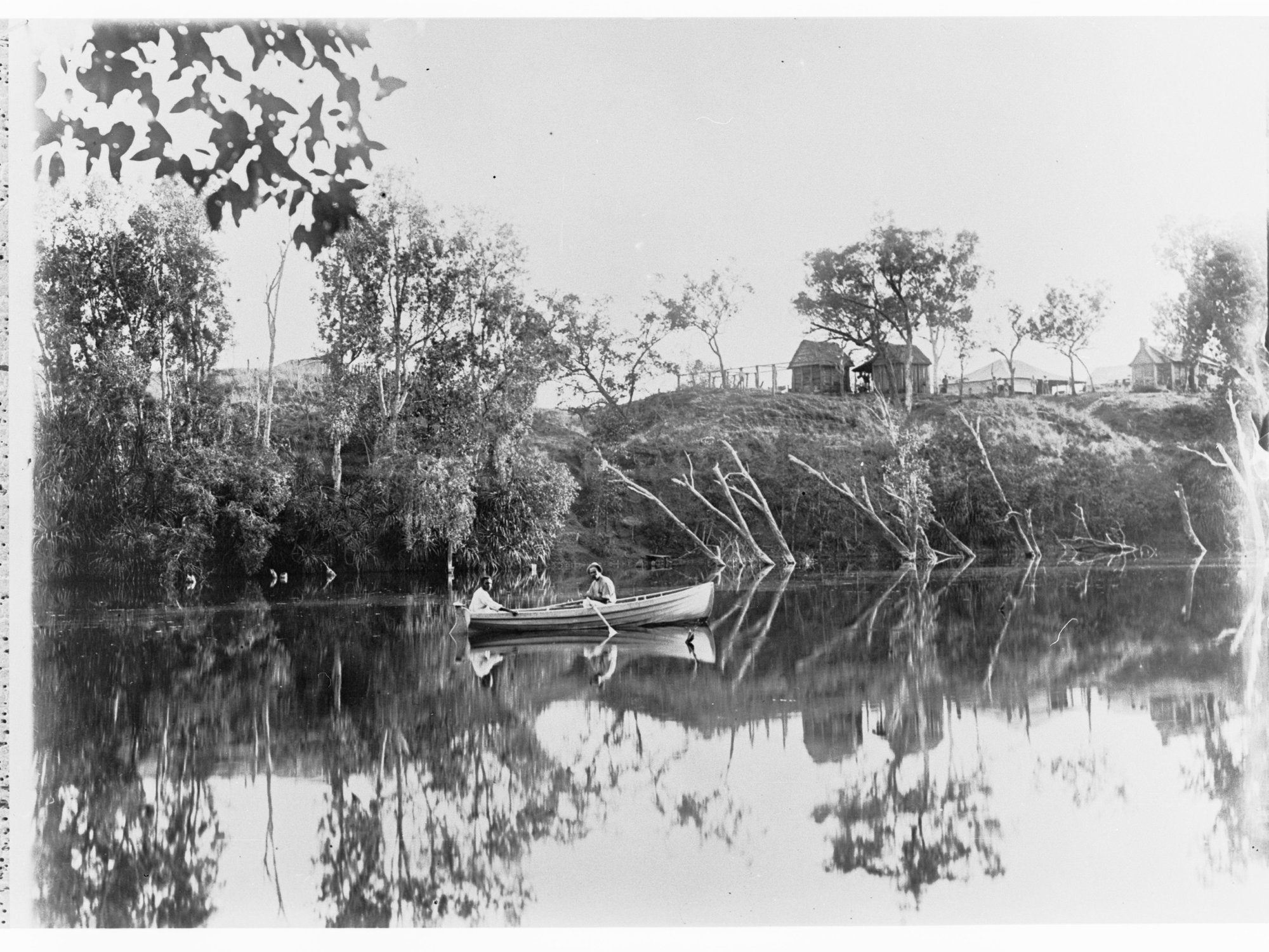 Two men in a rowboat on a river - Northern Territory