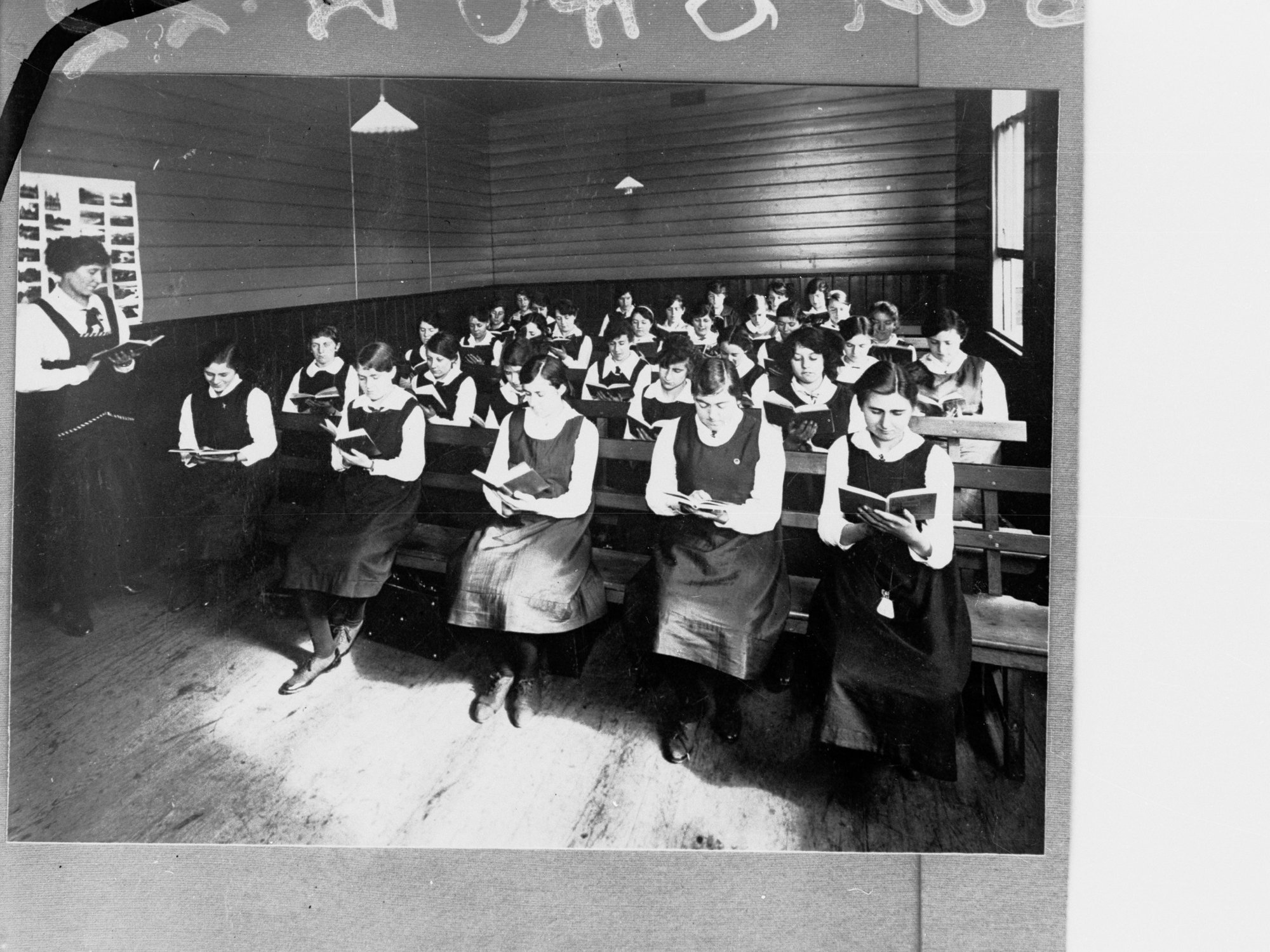Schoolgirls Reading in Classroom