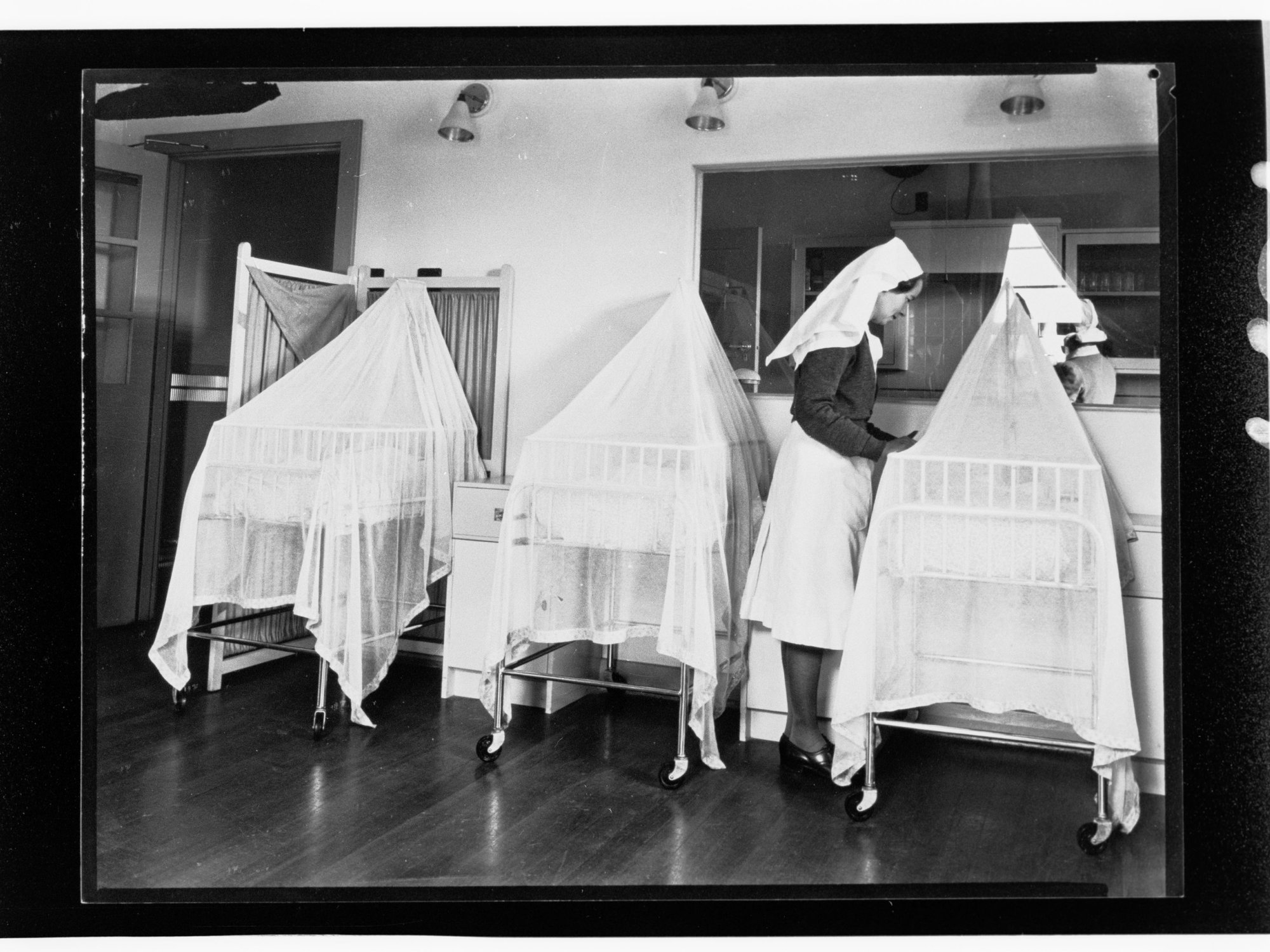 Children's Welfare Department - nurse attending babies in bassinets