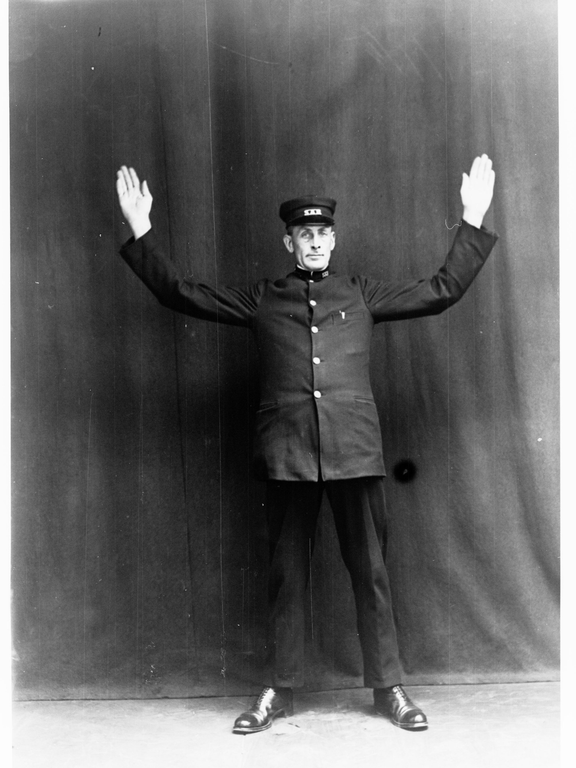 Porter demonstrating railway hand signals