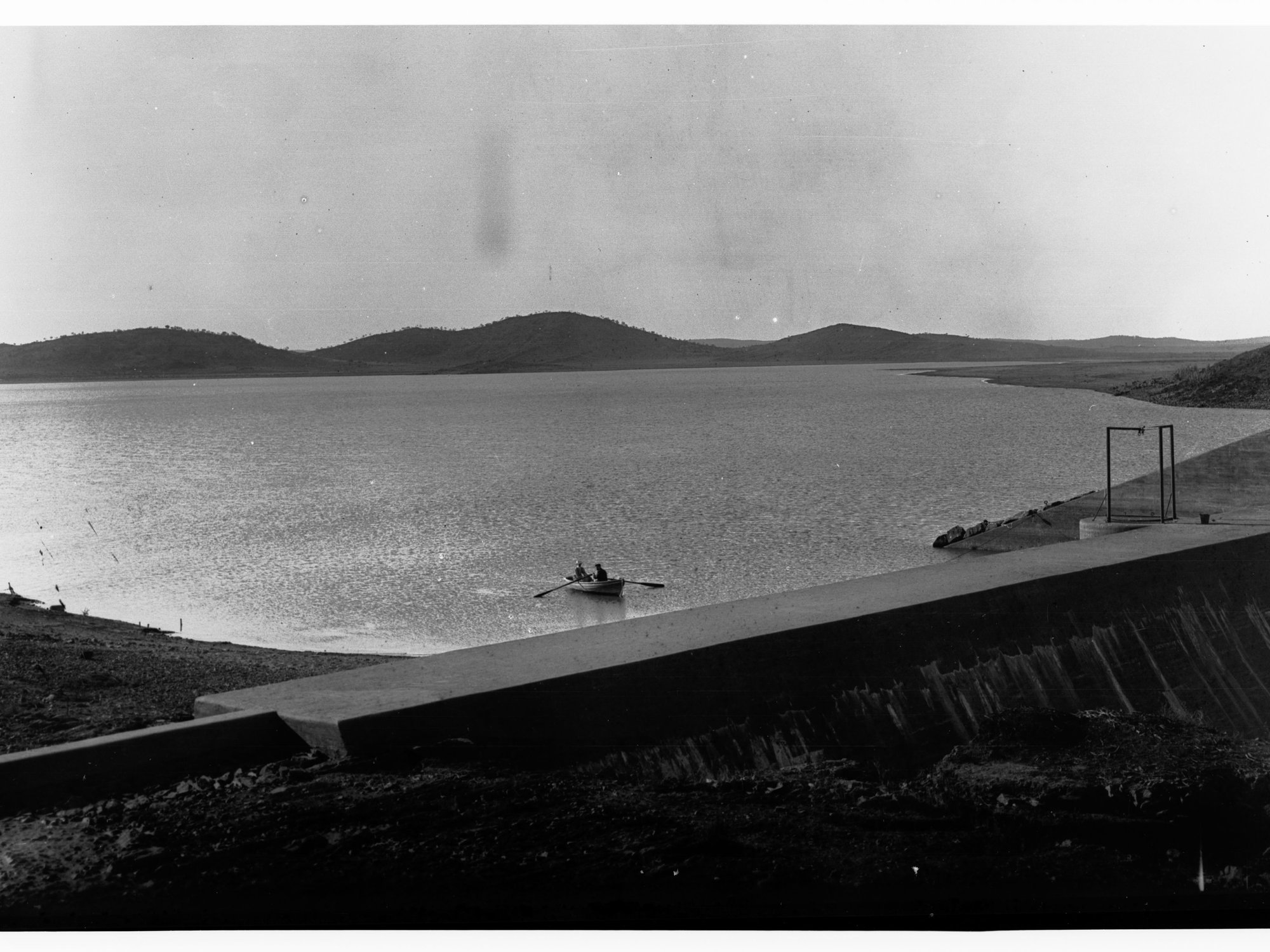 Reservoir Showing Two Men in a Row Boat