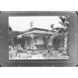 Front view of house showing lady in garden (Public Service Commissioner)