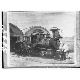 Steam locomotive showing railway employees