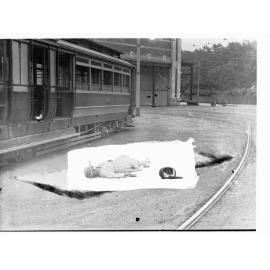 Simulation of tram accident - showing lady lying on ground next to tram