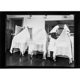 Children's Welfare Department - nurse attending babies in bassinets