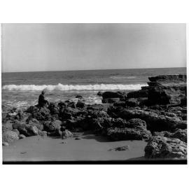 Man Sitting on Rocks at Port Noarlunga