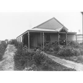 Men Sitting on the Verandah of a House