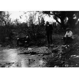 Men sitting on rocks next to a spring - near Mount Gambier