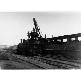 Loading coal from bunkers into 1st class locomotive at Mile End