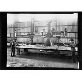 Whyalla - two men using equipment (No. 3 counter sinker)