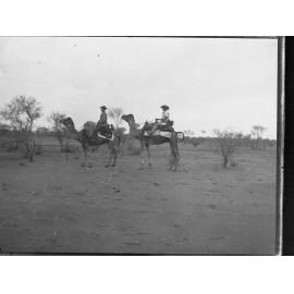 Two men riding camels - Northern Territory