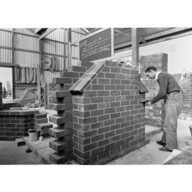 Education Department Trade School showing a student doing brickwork