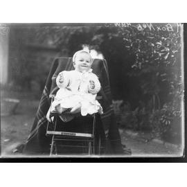 Baby sitting in garden