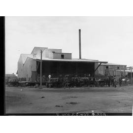 Men loading wheat sacks at flour mill Port Adelaide 