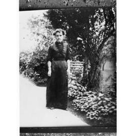 Woman standing in a garden - full length portrait