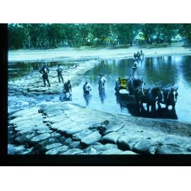 Men Putting Sandbags Across River Murray