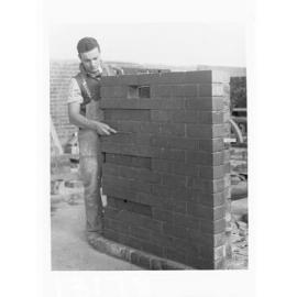 Education Department Trade School showing a student doing brickwork