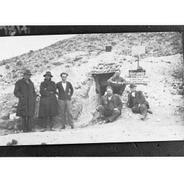 Men standing outside an underground post office - branch of Commonwealth Bank of Australia (Coober Pedy)