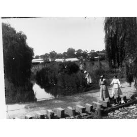 Young girls walking on stepping stones, Burton Street, Clare