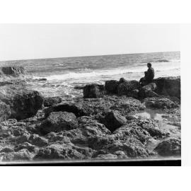 Man sitting on rocks at Port Noarlunga