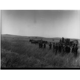 Lake View Field Trials - Men in field by a harvester