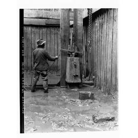 Glenelg Sewerage showing man in a trench operating a pile driver