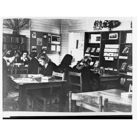 School Library Showing Girls at Tables Reading